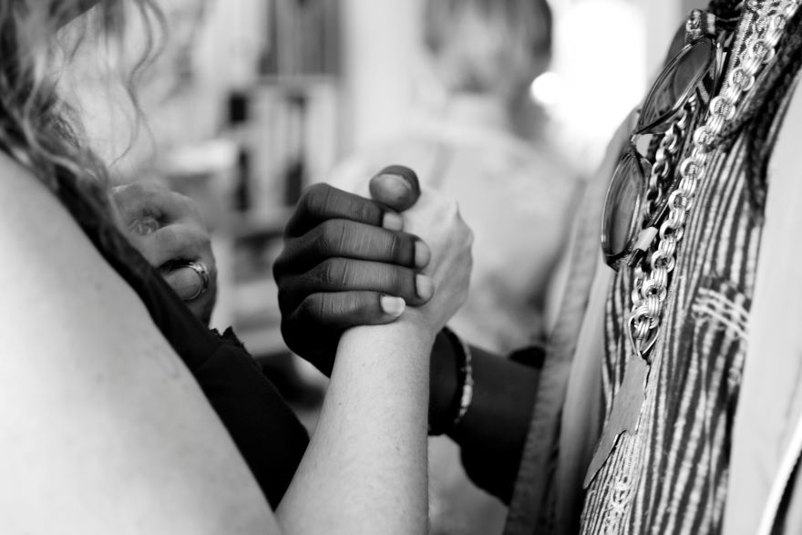 two people holding hands in solidarity